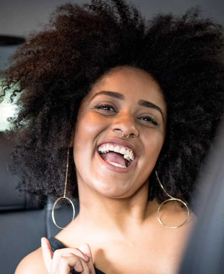 Every journey, a joy — Chauffeurz London guests Delighted international guest laughing inside Mercedes S-Class during Chauffeurz London chauffeur ride