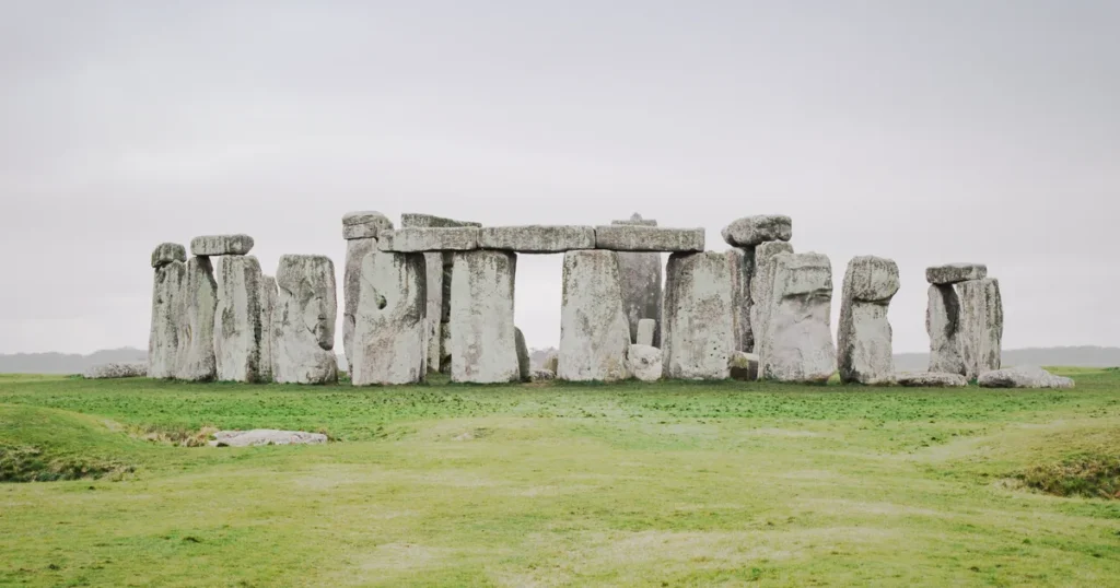 The Stonehenge stone circle on Salisbury Plain under an overcast sky, the destination of a private day tour from London