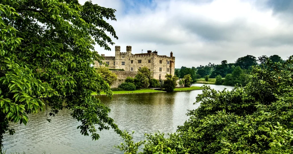 Leeds Castle reflected in its Kentish lake surrounded by parkland — Canterbury and Leeds Castle private day tour from London with Chauffeurz
